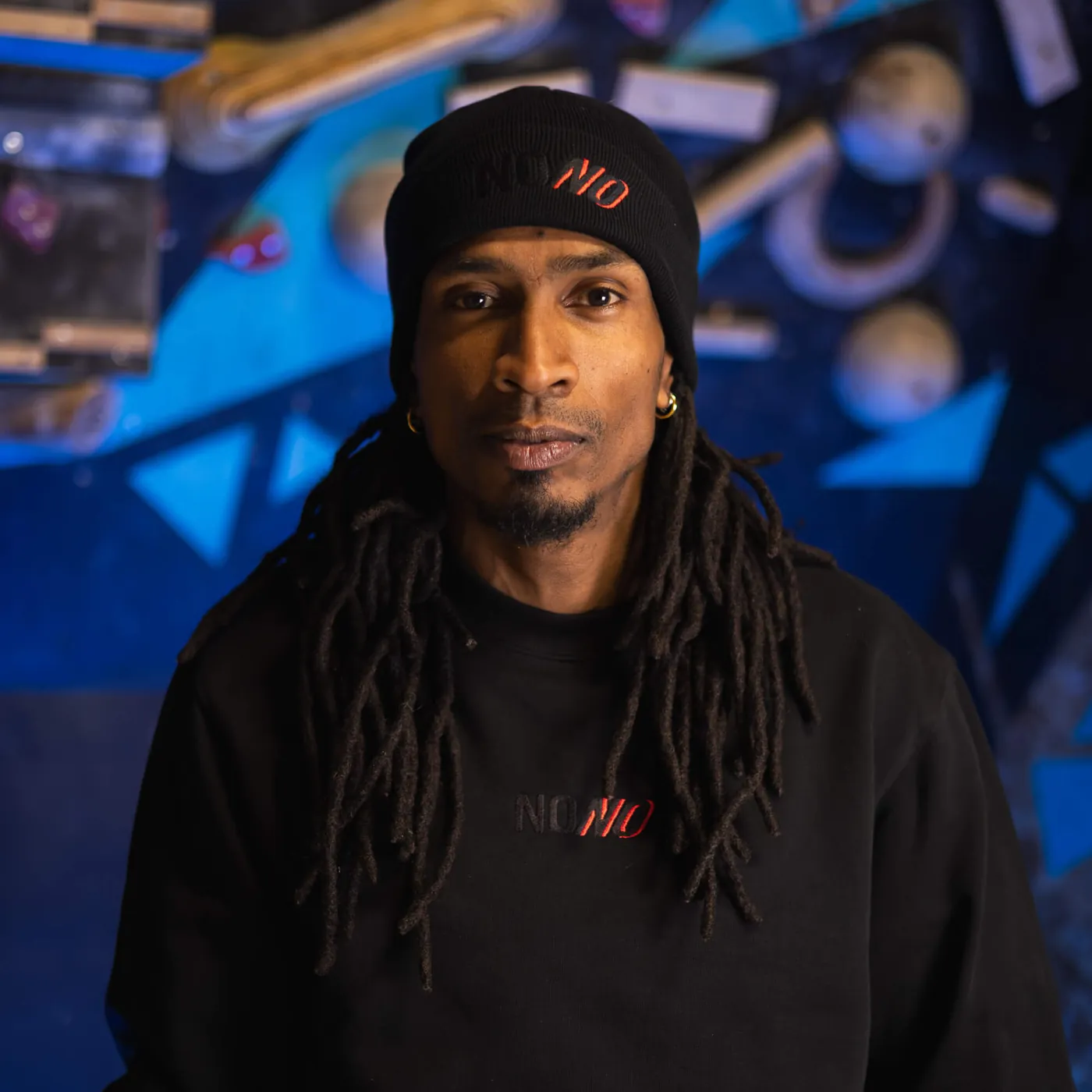 Man wearing the black NONO Signature beanie
